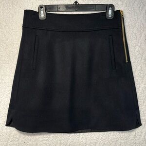 J Crew 100% wool black skirt with gold zipper detail and pockets! Size 6T